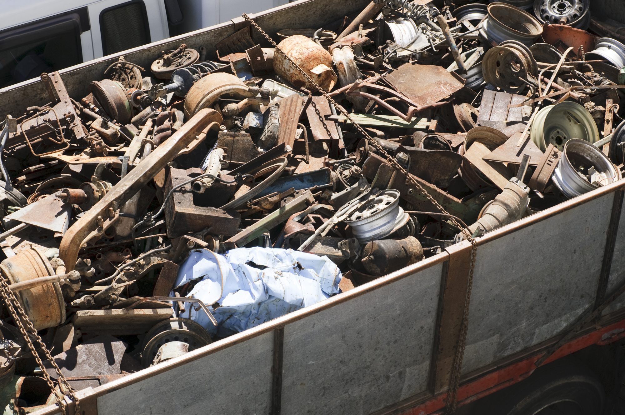 Assorted car and other scrap metal items in a large trailer.